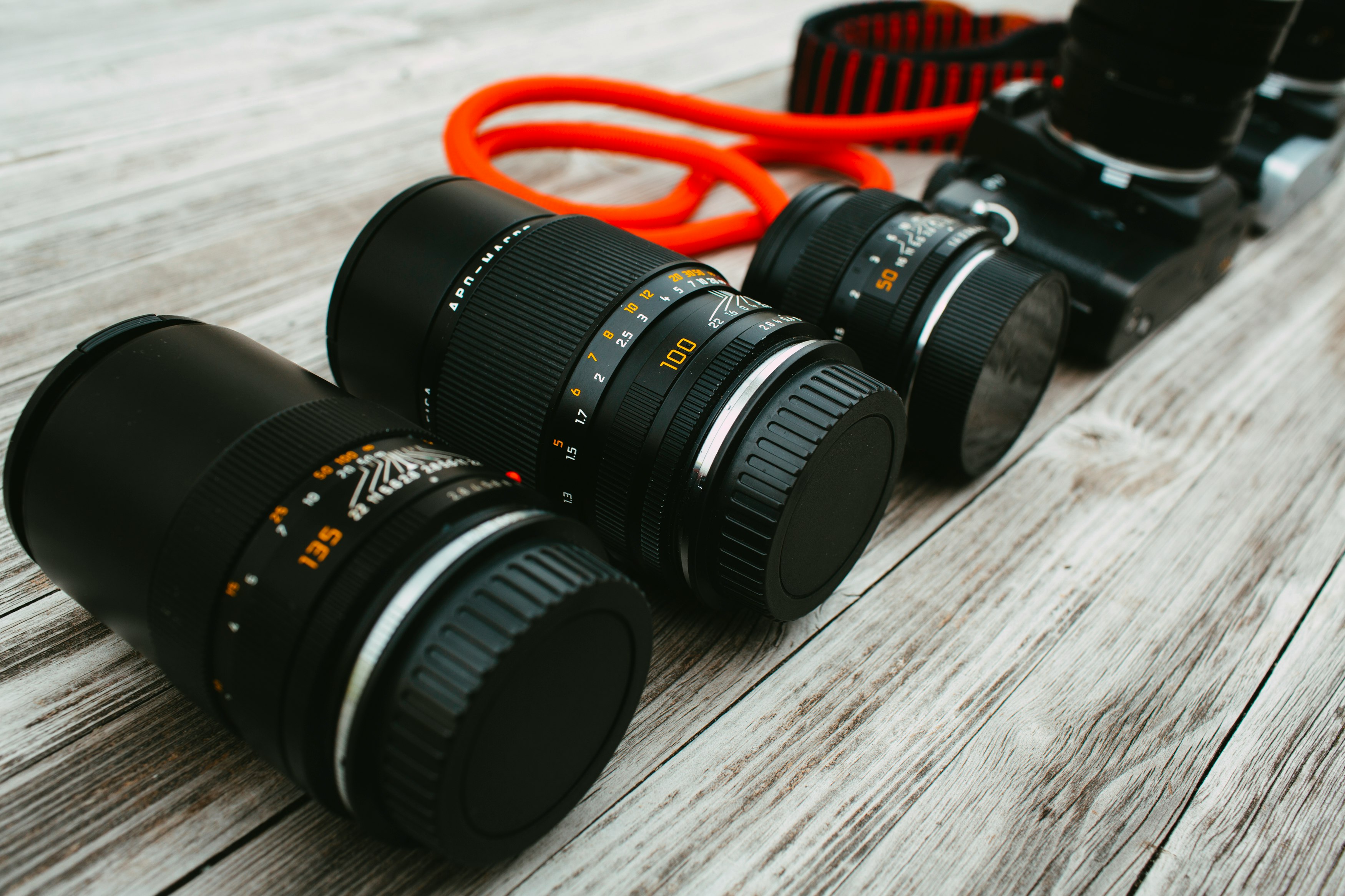 black nikon dslr camera lens on brown wooden table